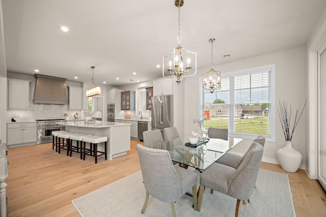 116 Spring Farm Rd, North Oaks, MN 55127 - dining space featuring a chandelier, recessed lighting, light wood-style flooring, and baseboards