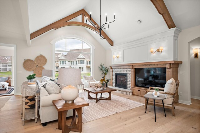 116 Spring Farm Rd, North Oaks, MN 55127 - living area featuring a brick fireplace, light wood-style floors, arched walkways, and baseboards