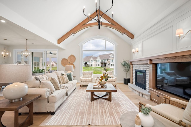 116 Spring Farm Rd, North Oaks, MN 55127 - living room featuring a chandelier, light wood-type flooring, a brick fireplace, and baseboards