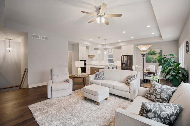 living room with recessed lighting, visible vents, a ceiling fan, wood finished floors, and baseboards