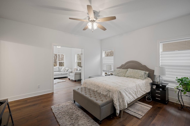 bedroom featuring ceiling fan, baseboards, and dark wood-style flooring