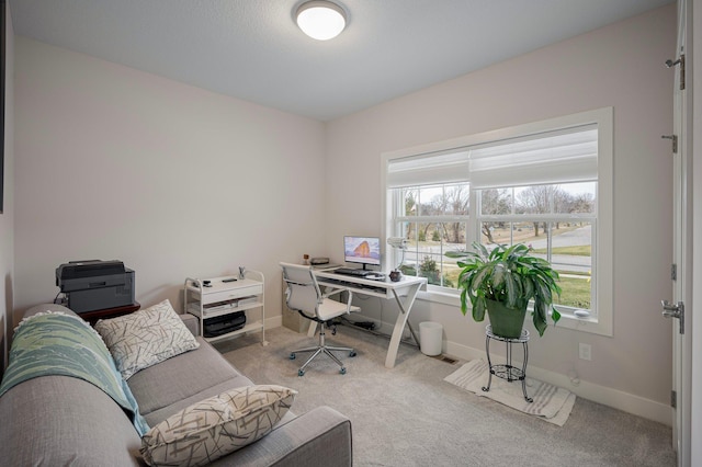 office featuring light carpet and baseboards