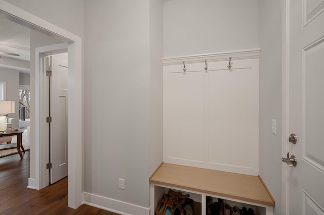 mudroom with dark wood-style floors and baseboards