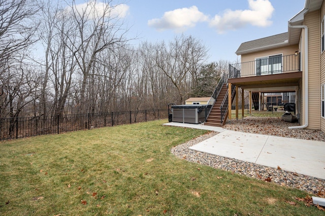 view of yard featuring a patio, stairway, a fenced backyard, and a hot tub