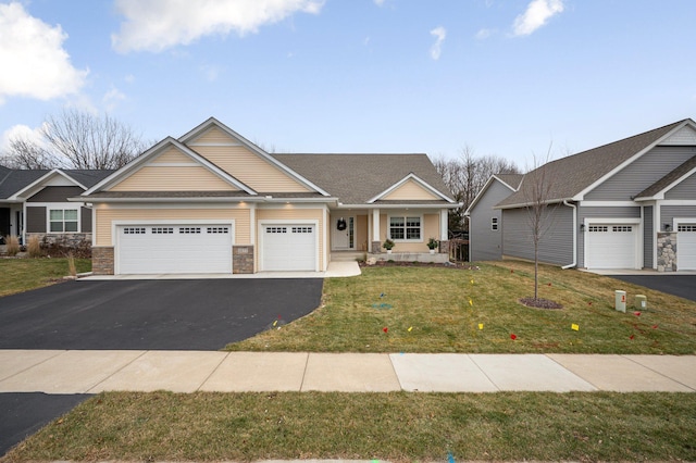 craftsman-style house with a garage, driveway, a front lawn, and a porch