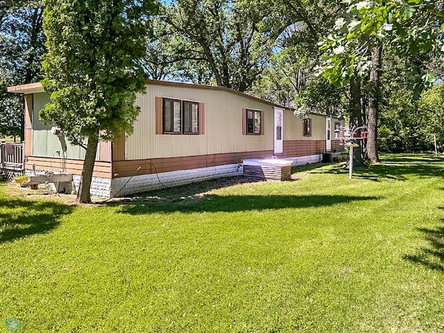 exterior space featuring a front lawn and central air condition unit