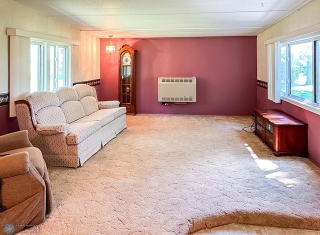 living area with light carpet and heating unit