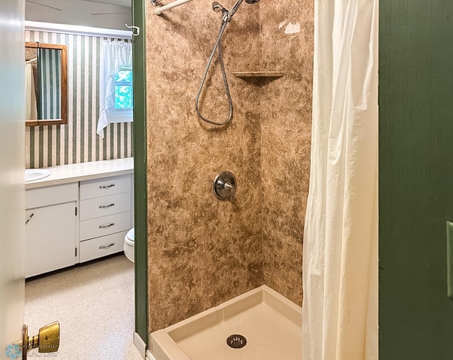 bathroom featuring a stall shower and a sink