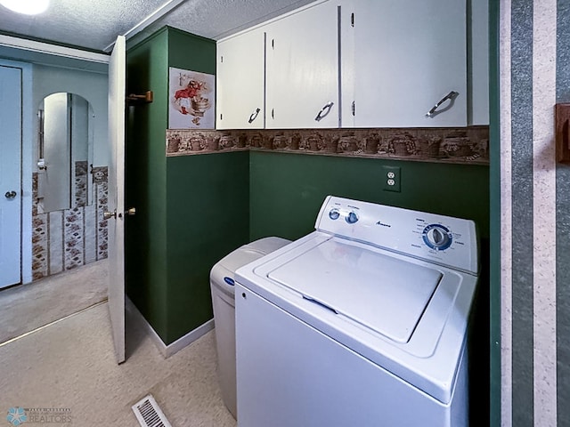 laundry area with visible vents, washer / clothes dryer, cabinet space, and a textured ceiling