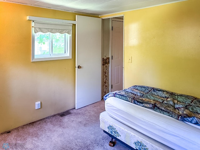 bedroom featuring light carpet and visible vents