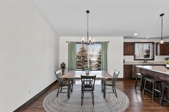 dining area featuring recessed lighting, baseboards, an inviting chandelier, and dark wood-style floors