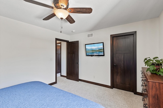 unfurnished bedroom featuring a ceiling fan, baseboards, visible vents, and light carpet