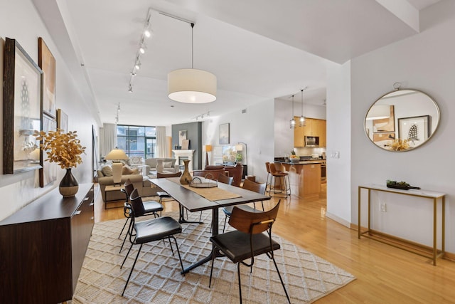 dining room with light wood-style floors and baseboards