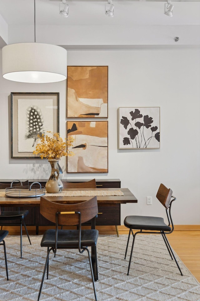 dining space with wood finished floors