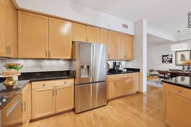 kitchen featuring hanging light fixtures, light brown cabinetry, backsplash, and stainless steel fridge with ice dispenser