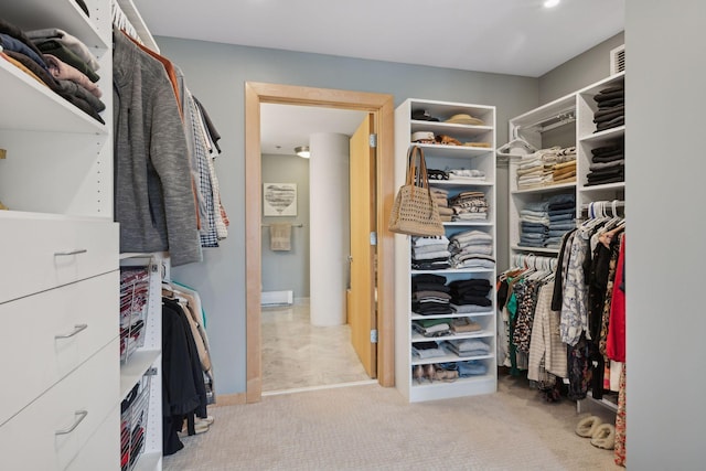 walk in closet featuring light carpet