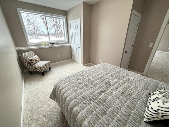 bedroom with light carpet and baseboards