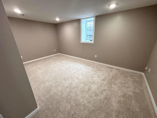 below grade area featuring carpet and baseboards