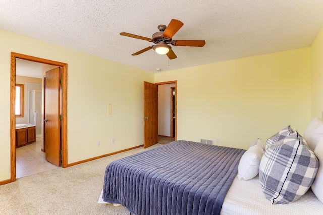 bedroom with ceiling fan, a textured ceiling, light carpet, visible vents, and baseboards