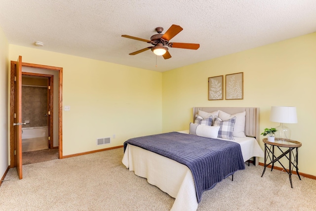 bedroom with a textured ceiling, baseboards, visible vents, and light colored carpet