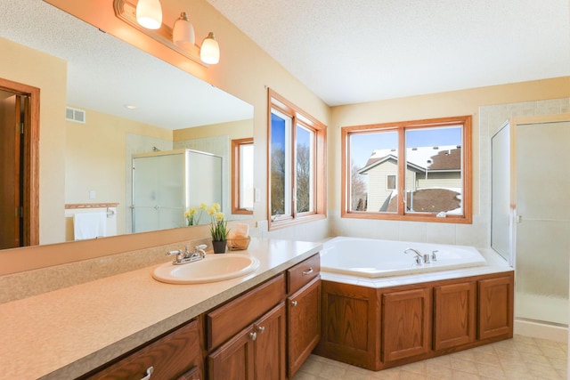 bathroom featuring a shower stall, visible vents, and a textured ceiling