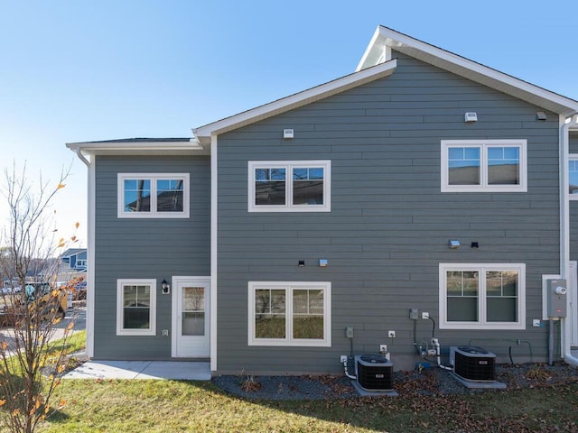 rear view of house featuring a patio area and central air condition unit