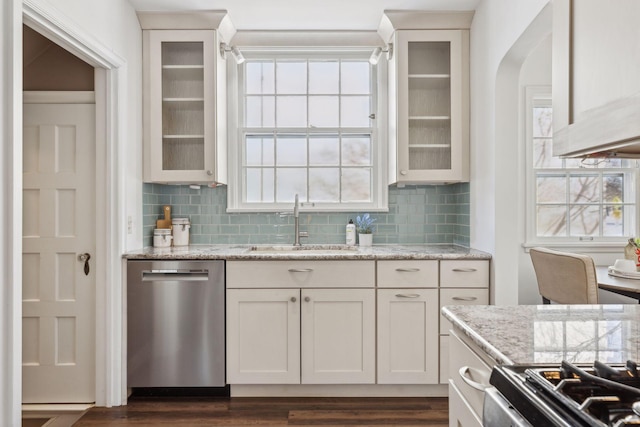 kitchen featuring white cabinetry, dishwasher, and light stone countertops