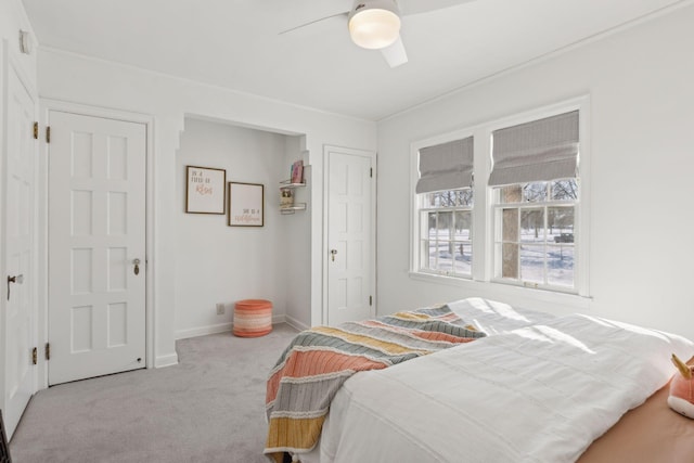 bedroom featuring baseboards, a ceiling fan, and light colored carpet