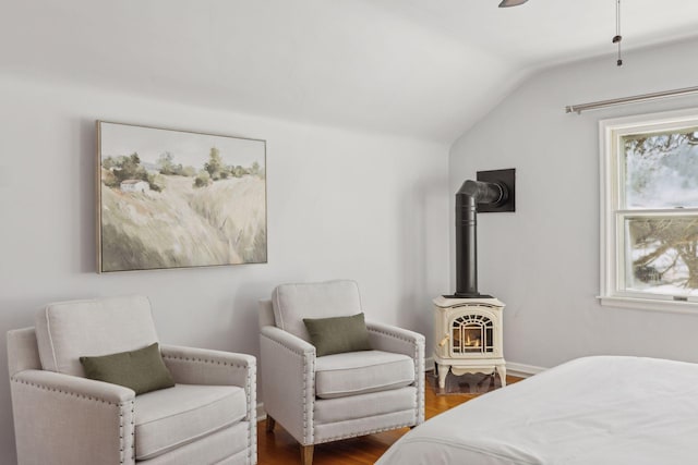 bedroom with lofted ceiling, ceiling fan, baseboards, and wood finished floors