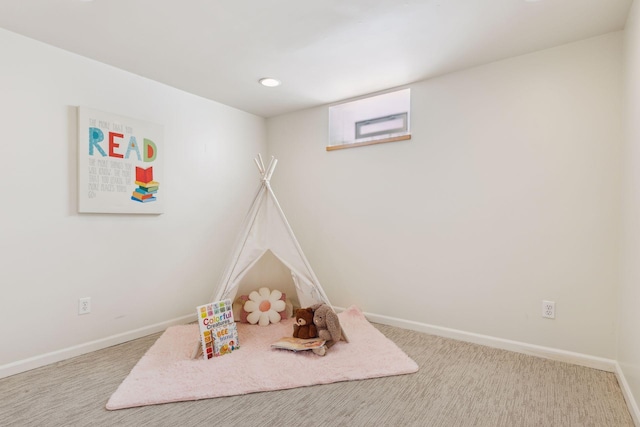 game room featuring light colored carpet and baseboards