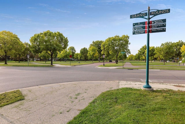 view of street with sidewalks, traffic signs, and curbs