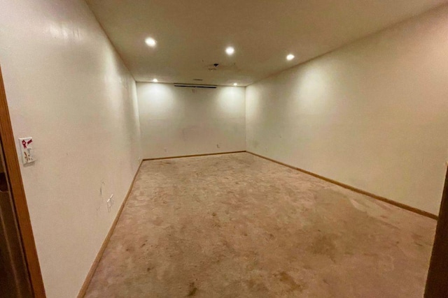 spare room featuring light carpet, baseboards, and recessed lighting