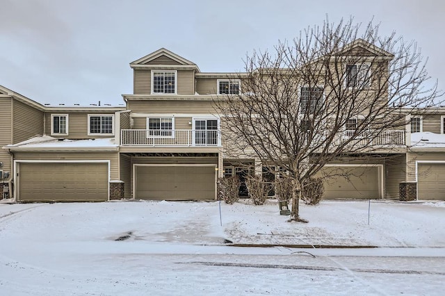 view of property featuring a balcony and a garage