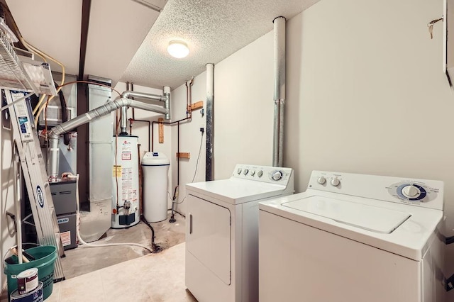 laundry area with gas water heater, washer and clothes dryer, and a textured ceiling