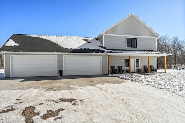 view of front of home featuring covered porch, an attached garage, and concrete driveway