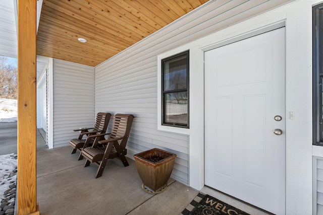 view of exterior entry with covered porch