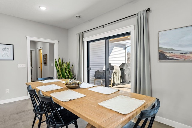 dining space with concrete flooring, recessed lighting, and baseboards