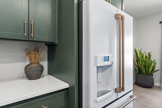 details featuring high end fridge, carpet flooring, and baseboards