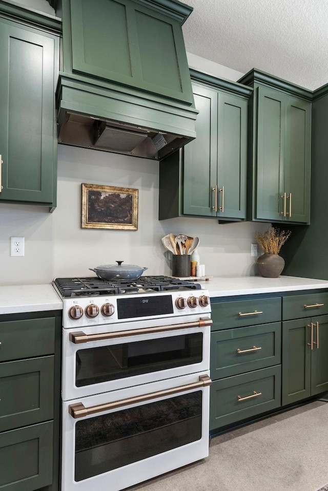 kitchen featuring custom exhaust hood, light countertops, a textured ceiling, double oven range, and green cabinets