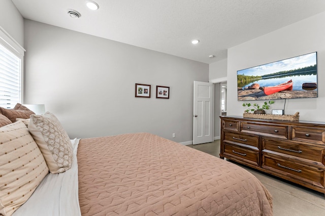 bedroom with a textured ceiling, baseboards, and recessed lighting