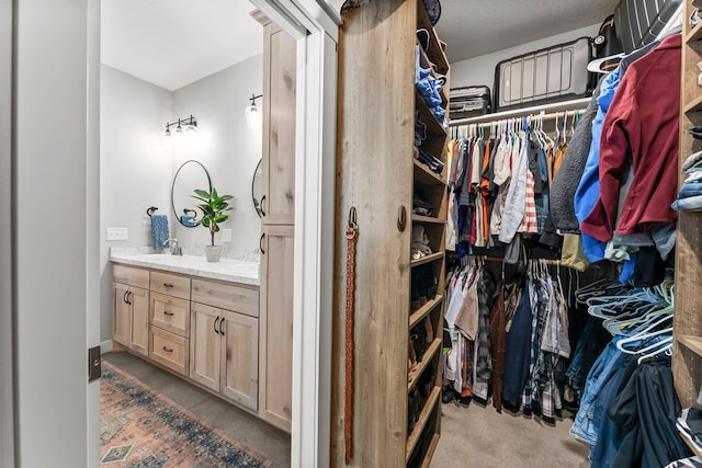 walk in closet featuring a sink