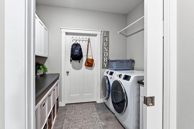 washroom with cabinet space and separate washer and dryer