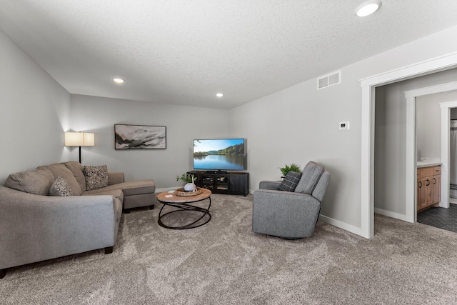 carpeted living room featuring recessed lighting, visible vents, a textured ceiling, and baseboards