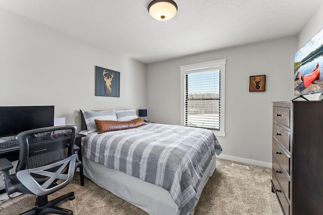 bedroom featuring light carpet, a textured ceiling, visible vents, and baseboards