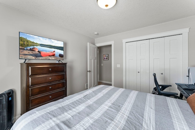 bedroom with a closet and a textured ceiling