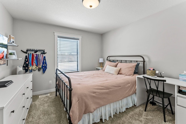 bedroom featuring a textured ceiling, baseboards, and carpet flooring