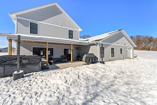 view of snow covered rear of property