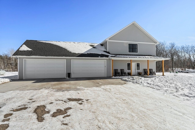 view of front of house featuring covered porch, driveway, and an attached garage