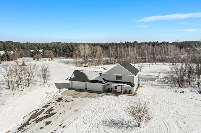 snowy aerial view with a view of trees