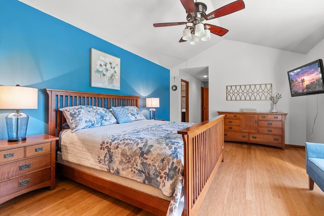 bedroom with ceiling fan, wood finished floors, and vaulted ceiling